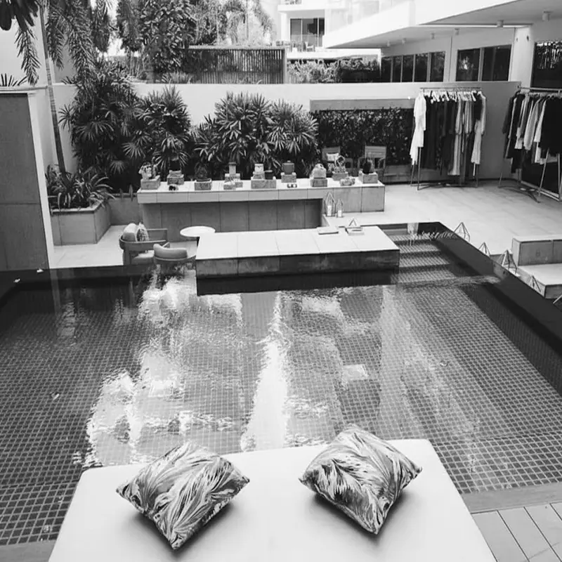 Destination styling in Dubai — clothing rails set up beside a private villa pool