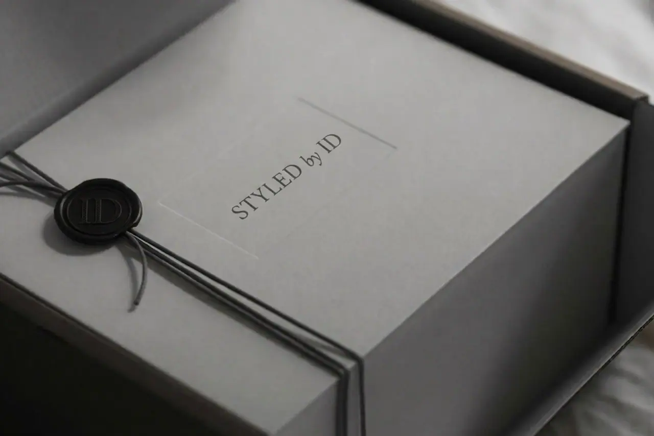 Grey Styled by ID gift box tied with cord and sealed with a black wax ID seal